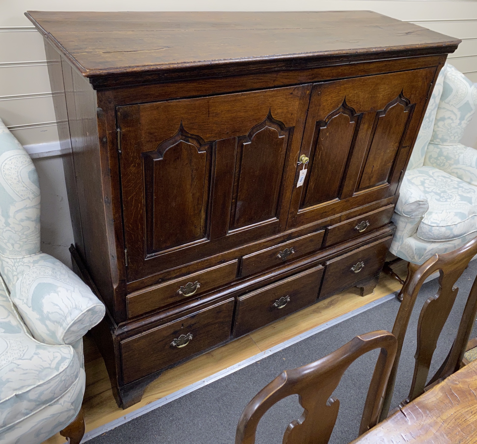 A George III oak press cupboard, width 142cm, depth 51cm, height 131cm